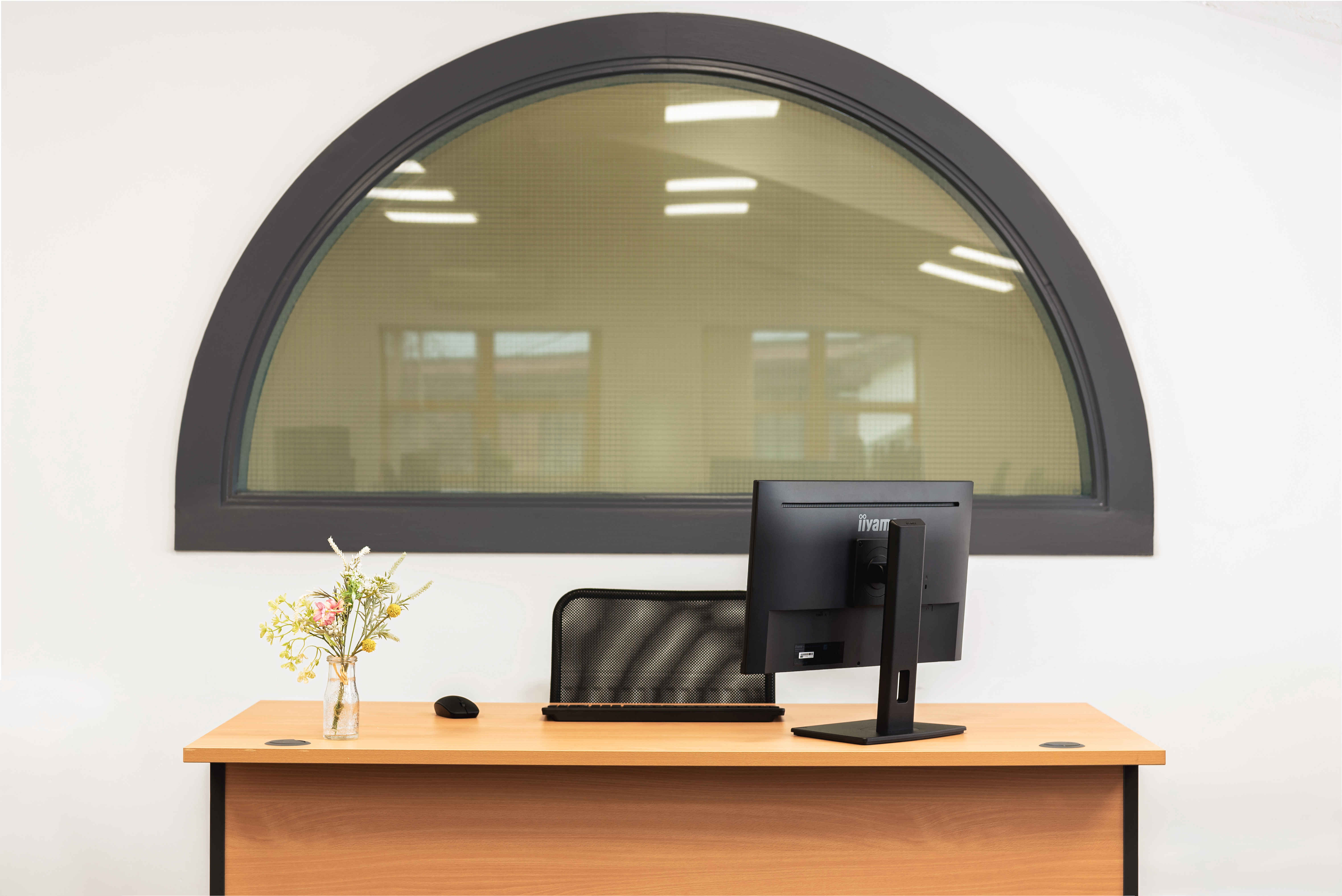 office desk with computer chair and flowers
