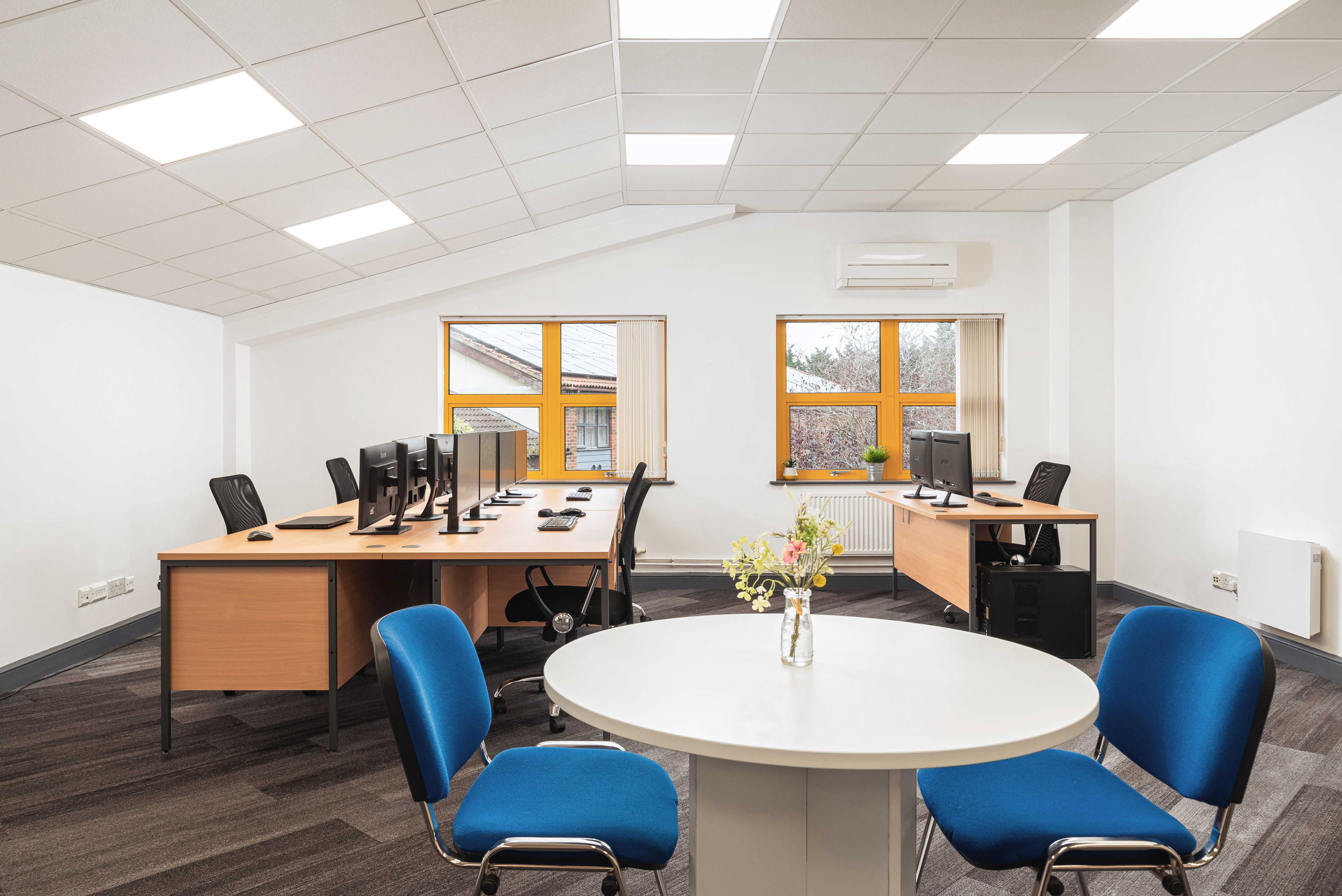 modern office room with desks chairs and computers