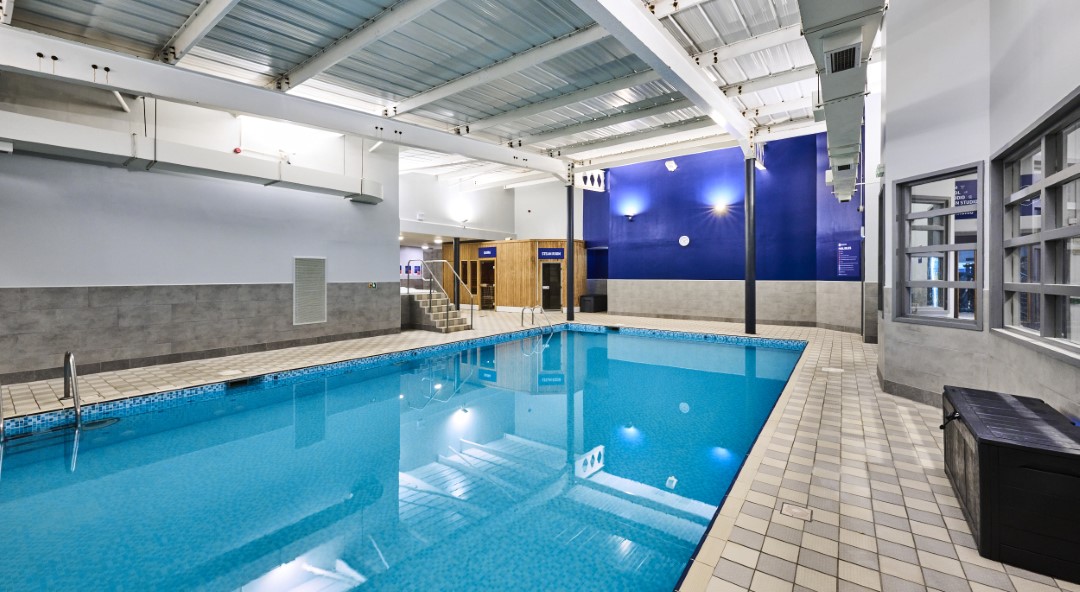 indoor swimming pool with clear blue water and tiled floor