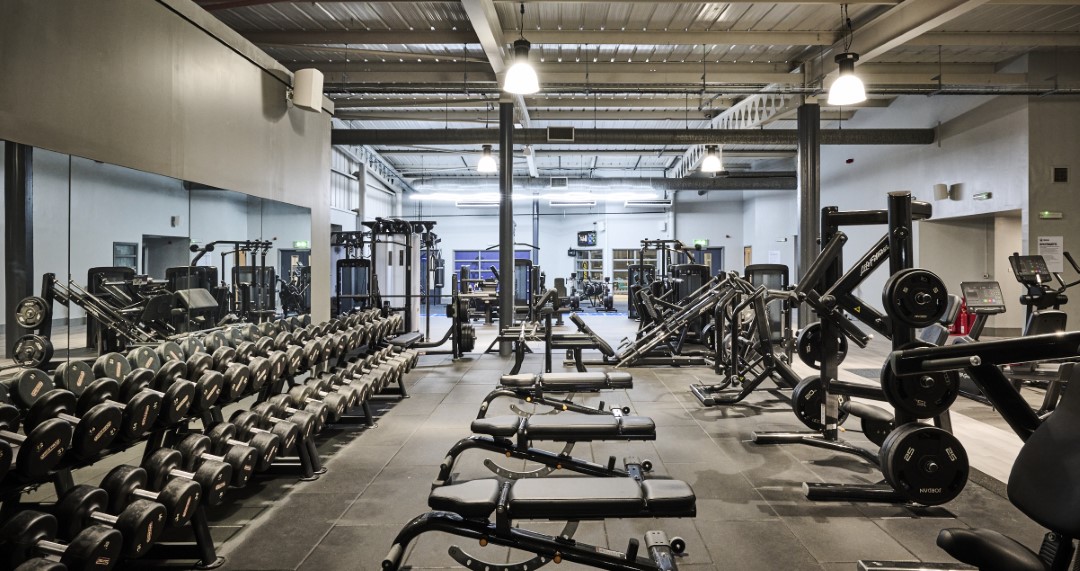 empty gym with weights benches and machines