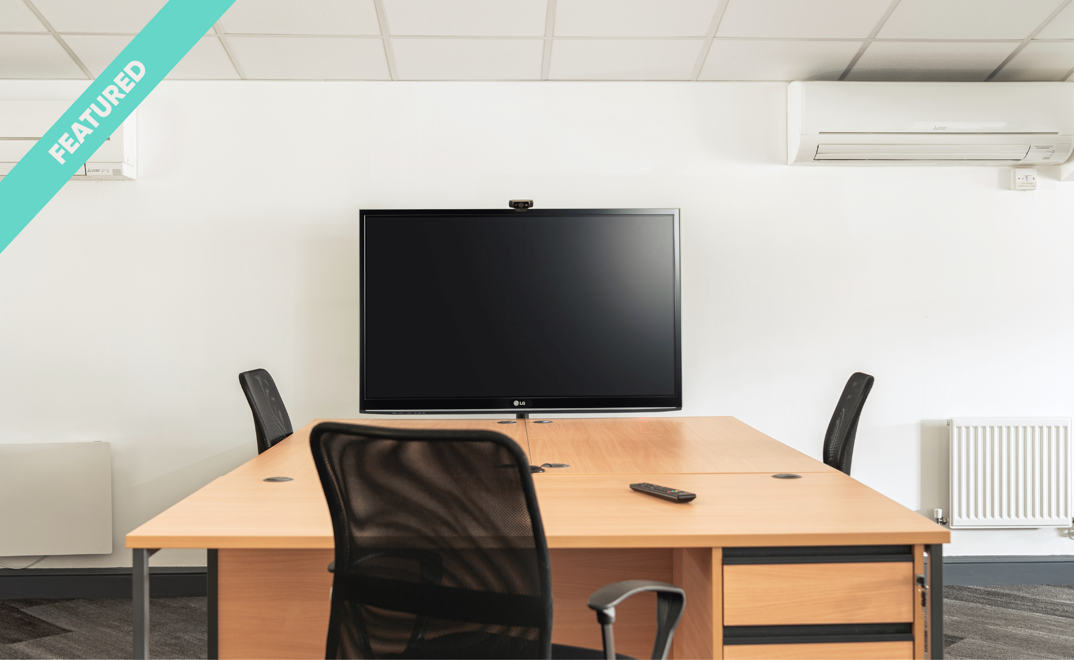 empty office meeting room with tv screen and chairs