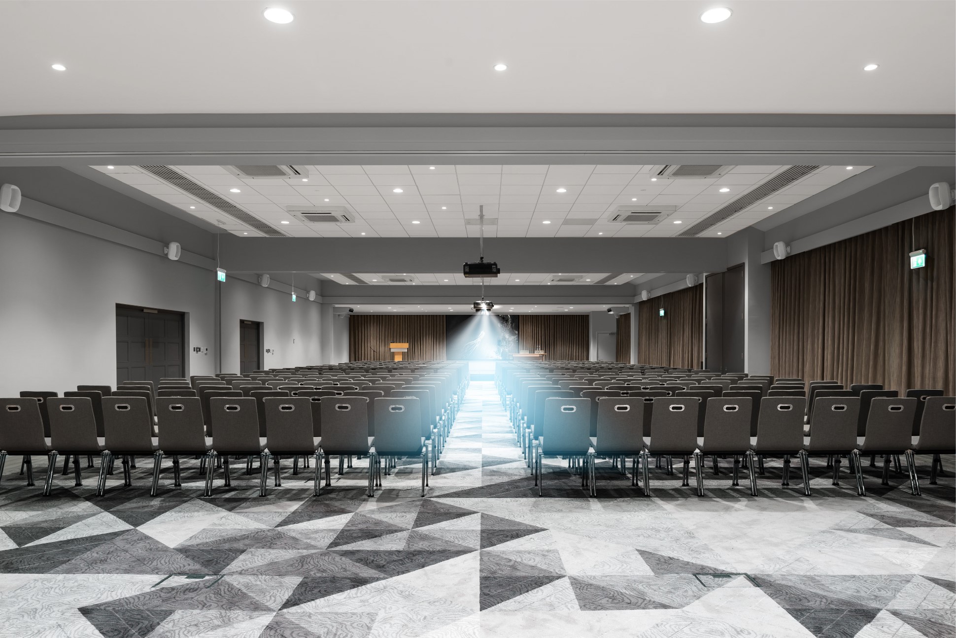 empty conference room with projector light on stage