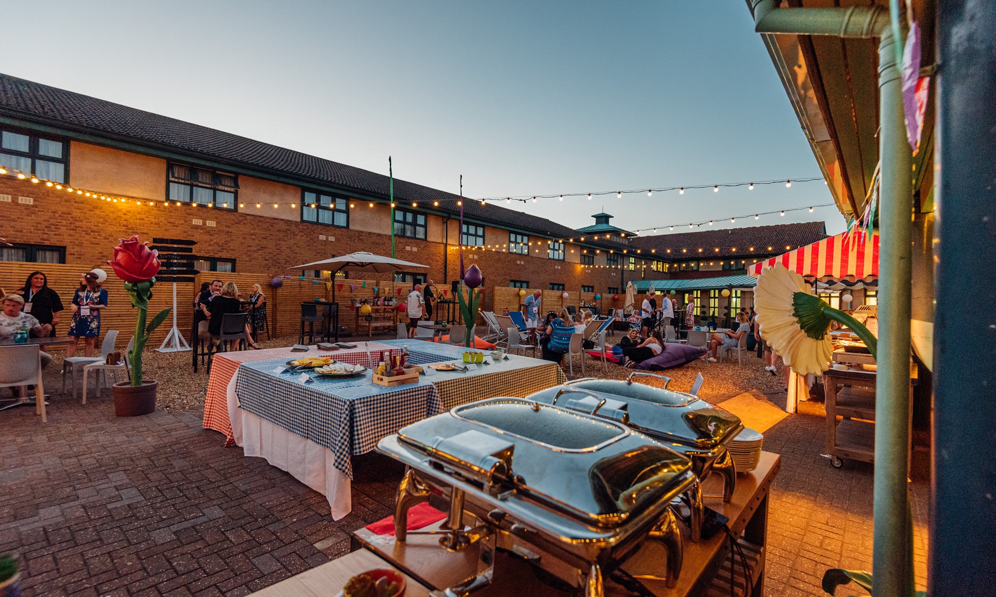 evening outdoor party with buffet and string lights