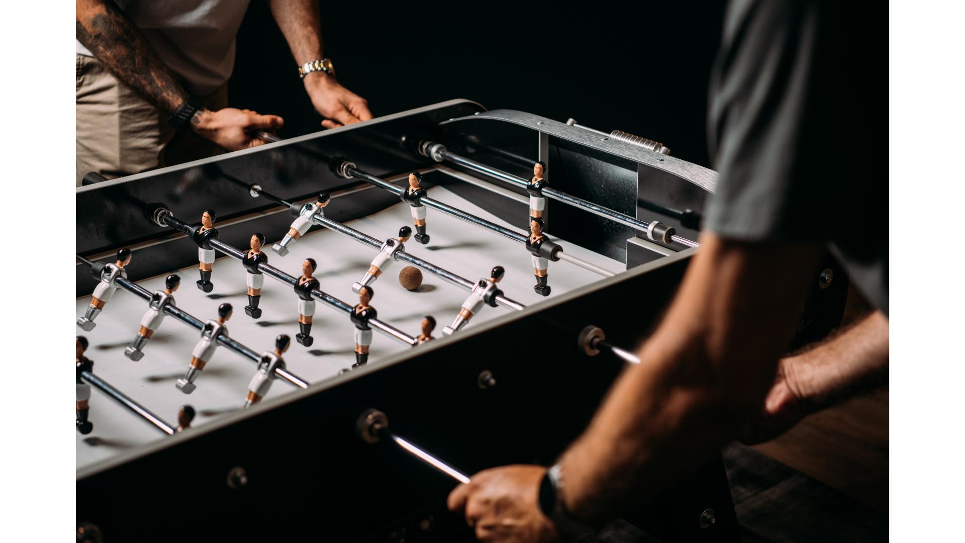 two people playing table football indoors