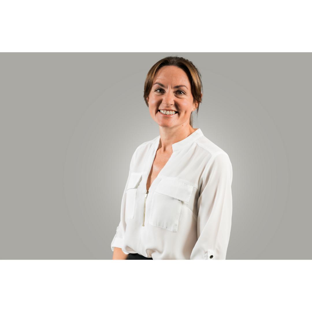 smiling woman in white shirt on grey background