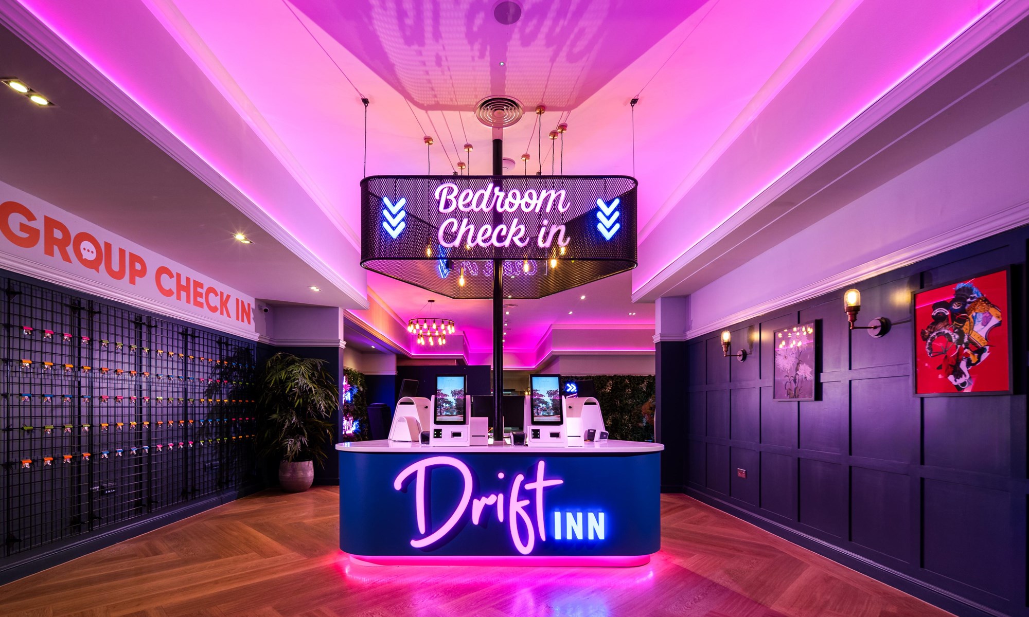 hotel reception desk with neon bedroom check in sign