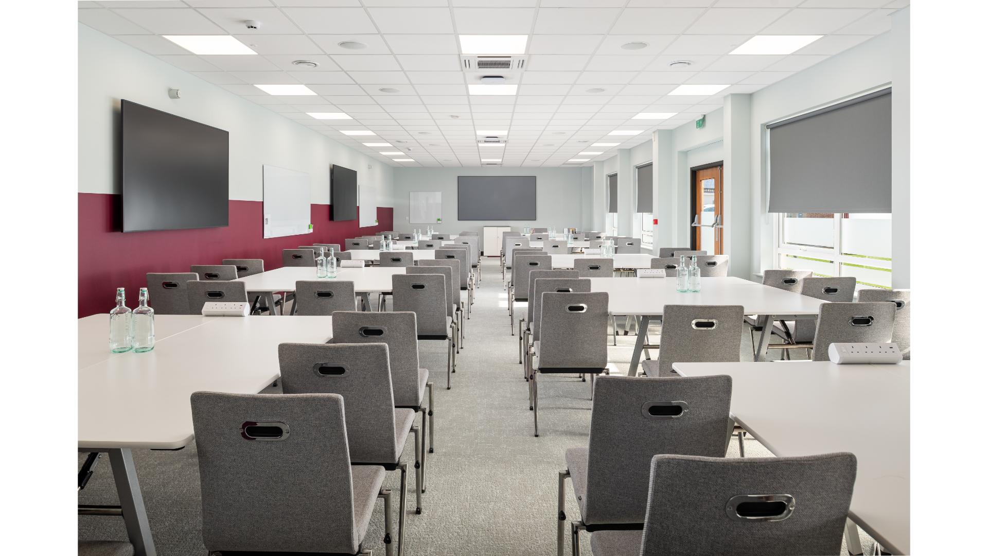modern conference room with rows of grey chairs
