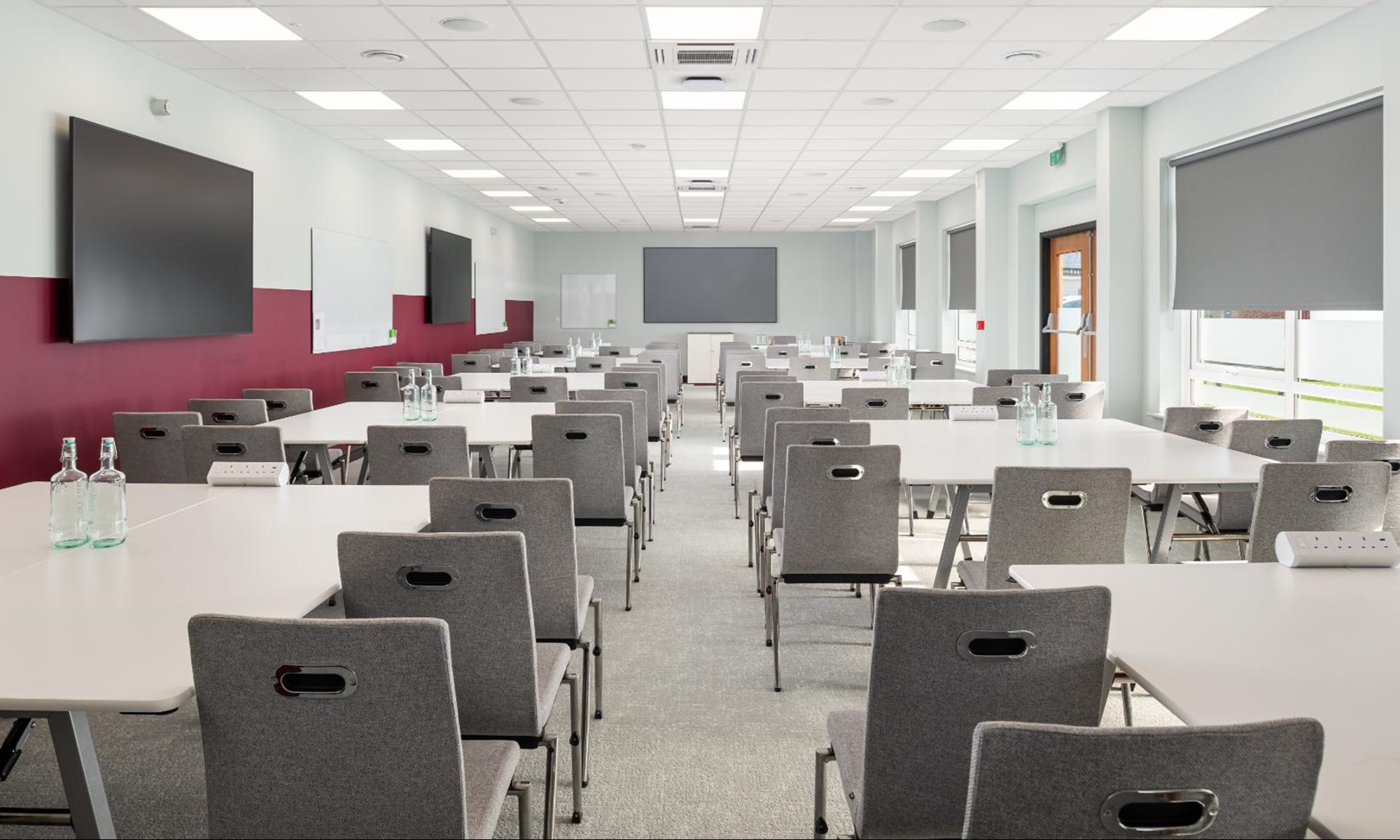 modern conference room with rows of grey chairs