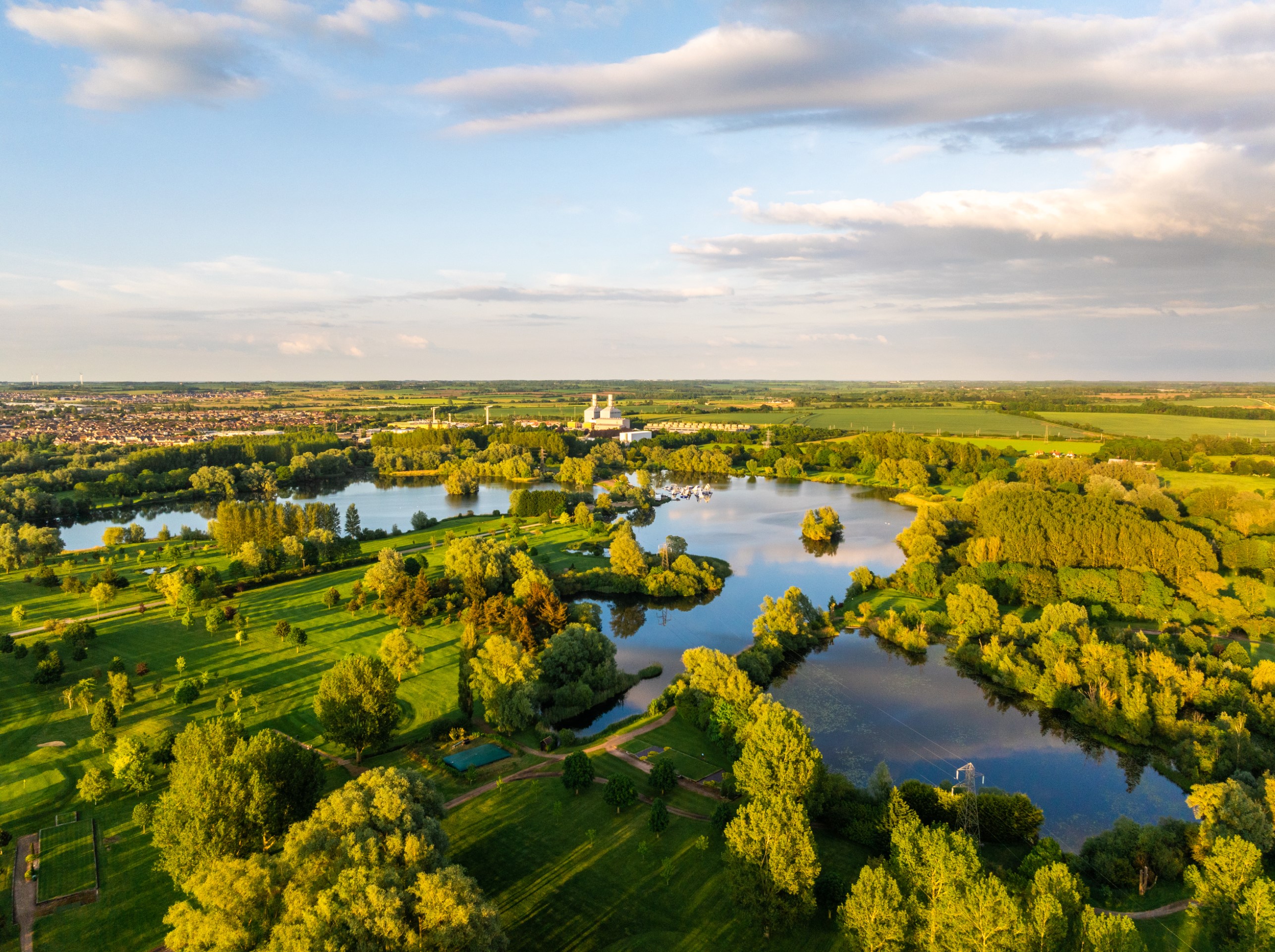aerial view of lakes fields and trees in countryside
