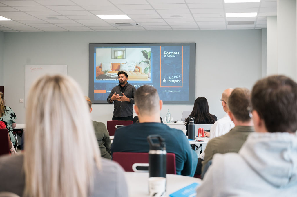 man giving presentation to seated audience in meeting room