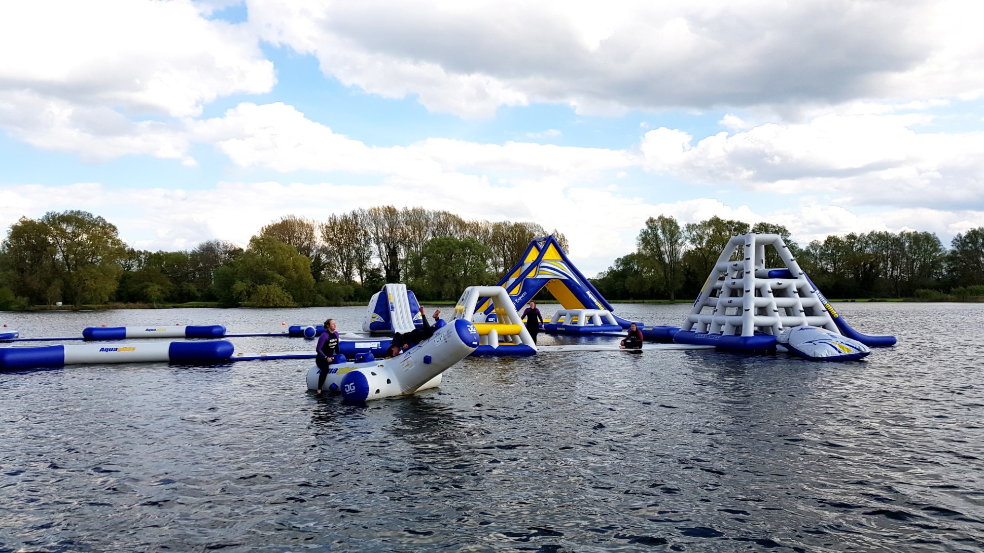 inflatable water park with people playing in lake